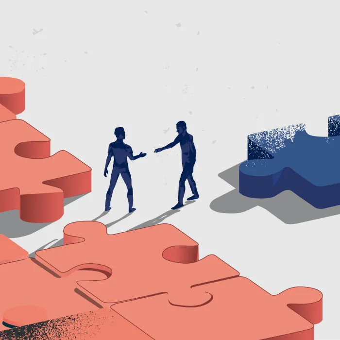 Two people meeting to discuss the insurance puzzle that comes with wealth management