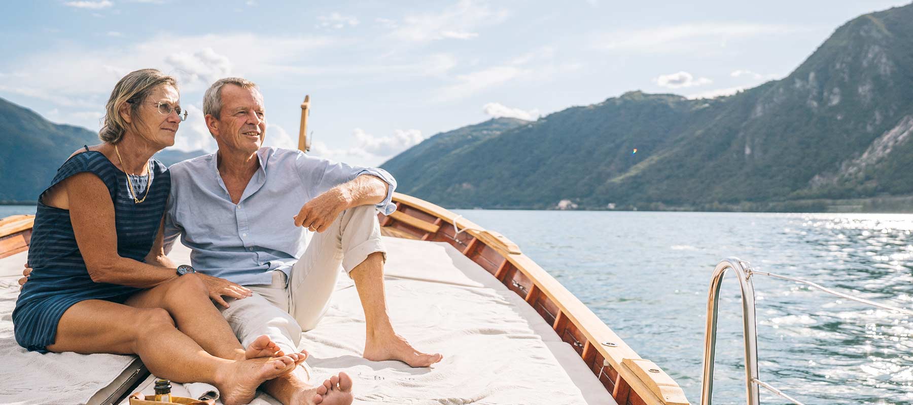 A senior couple enjoys a stunning view on a boat
