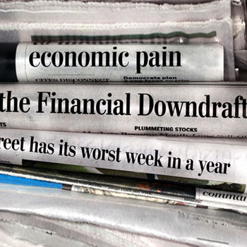Recession and investment headlines in financial newspapers