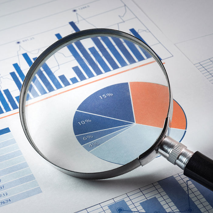 A magnifying glass hovers over a chart